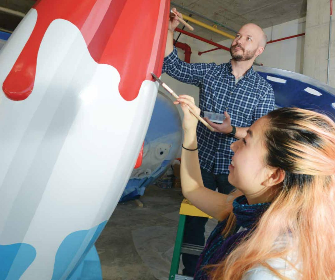 Steve and Cindy painting their sculpture, Rocket Pop